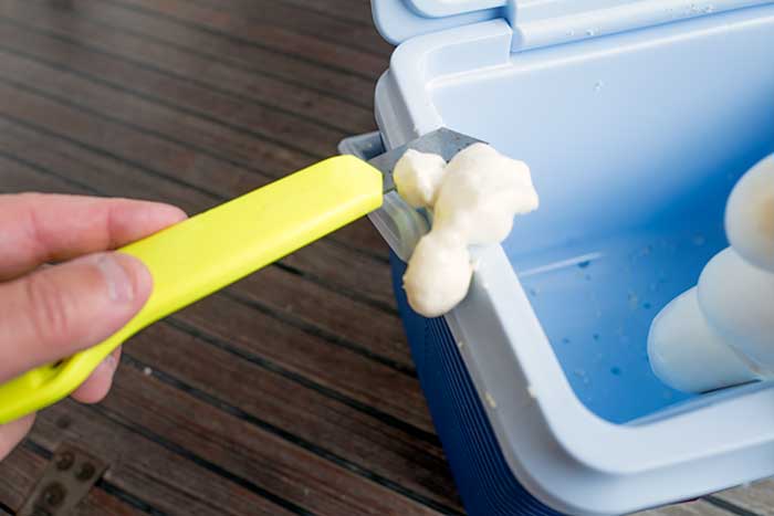 Using a knife to trim excess foam